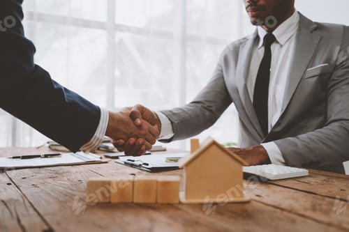 Preview: Real estate broker and client shaking hands after signing sale contract, home loan and congratulatin