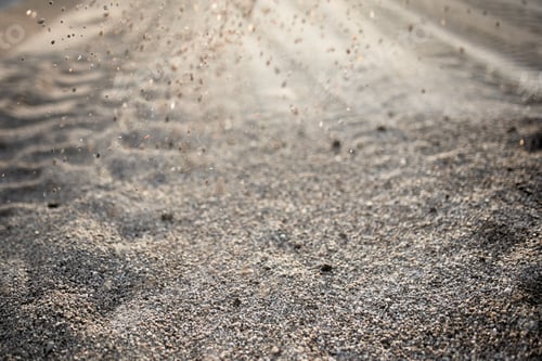Preview: Road of small stones close-up with a scattering of stones in the sun at sunset.