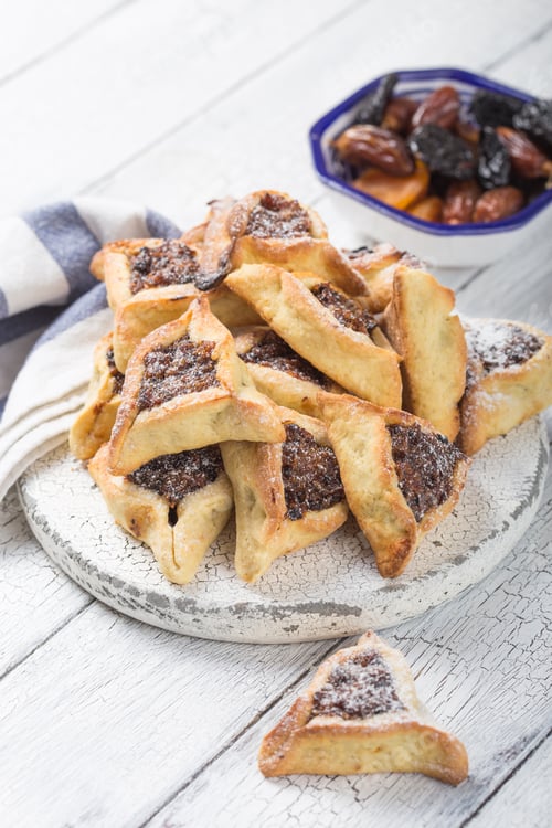 Preview: Traditional Jewish Hamantaschen cookies with dried apricots, dates. Purim celebration concept.