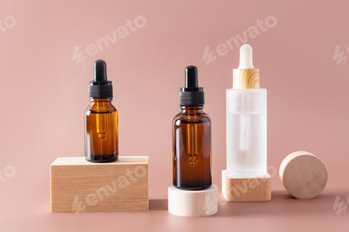 Preview: various cosmetic bottles with a dropper with an natural face care product stand on wooden shapes.
