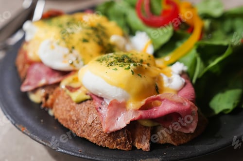 Preview: Delicious eggs benedict with greens in a cozy restaurant