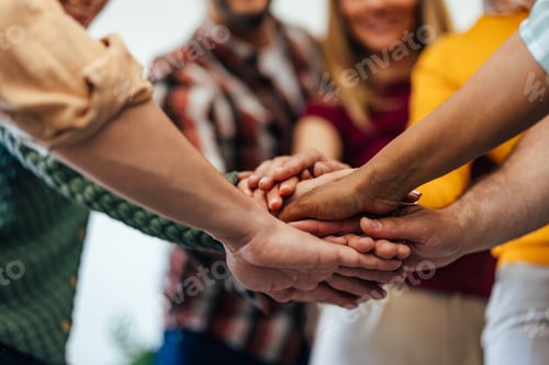 Preview: Group of People Uniting Hands to Represent Teamwork and Cooperation
