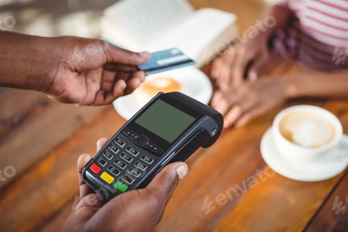 Preview: Waiter holding credit card machine
