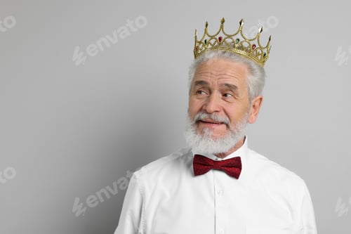 Preview: Senior man wearing luxury crown on grey background, space for text