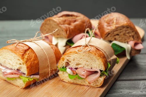 Preview: Sandwiches on a wooden board with different fillings served for lunch