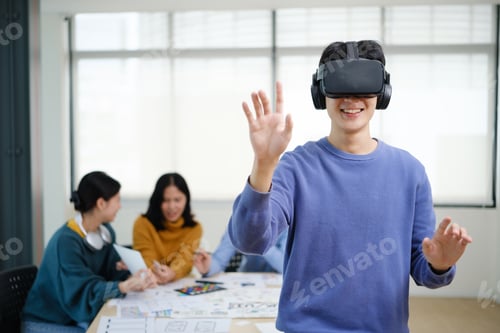 Preview: Excited young businessman testing virtual reality simulator glasses.