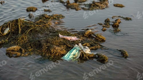 Preview: Coronavirus waste polluting the environment. Disposable masks trash sea