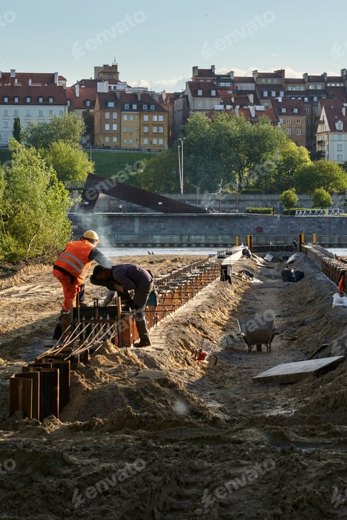 Preview: Vertical shot of an old pier under construction with workers in Warsaw, Poland