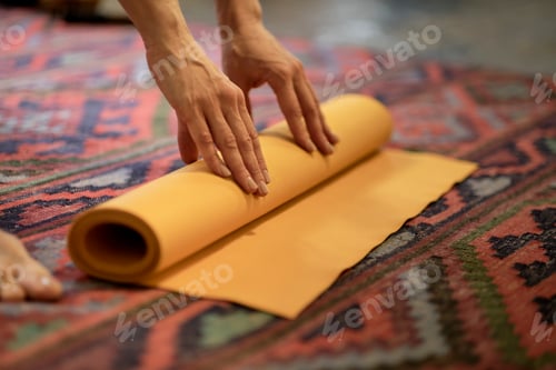 Preview: Woman rolling her mat after a yoga class