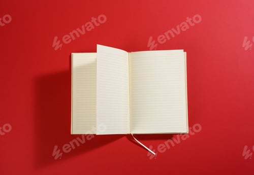 Preview: Open notebook with blank white sheets on red background