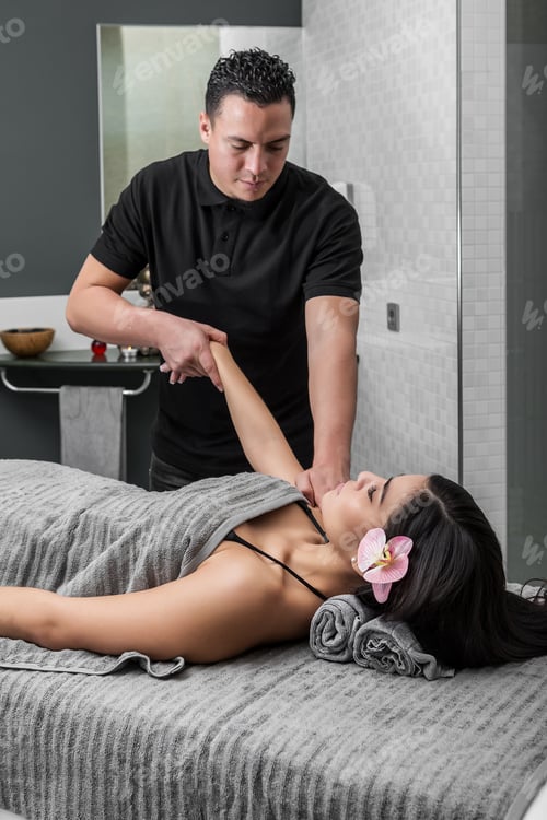 Preview: Man stretching hands of woman giving massage