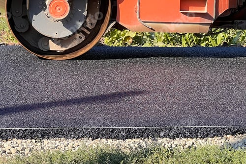 Preview: Asphalt paving roller. Road roller laying fresh asphalt, working on the new road construction site