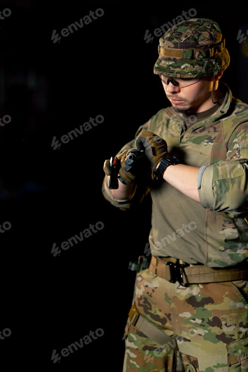 Preview: close-up at a professional shooting range a military trainer reloading a pistol ready to shoot