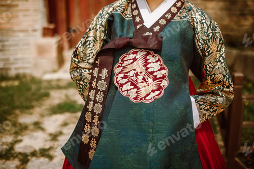 Preview: Midsection of a woman wearing a green South Korean traditional embroidered dress