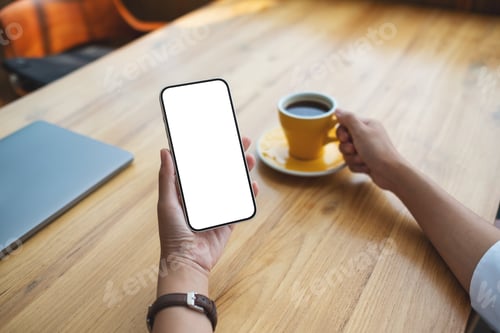 Preview: Mockup image of a woman holding mobile phone with blank desktop screen while drinking coffee