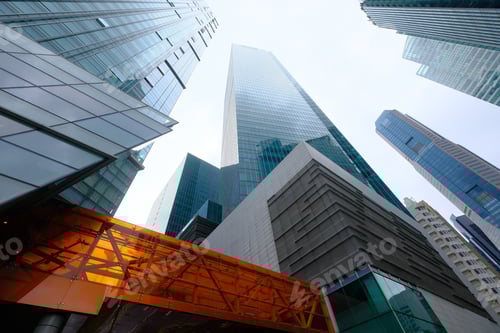 Preview: A stunning view of modern skyscrapers set against a dramatic cloudy sky in an urban cityscape