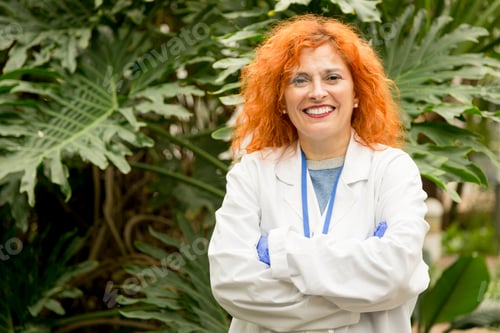 Preview: Smiley scientist looking at the camera with her arms crossed