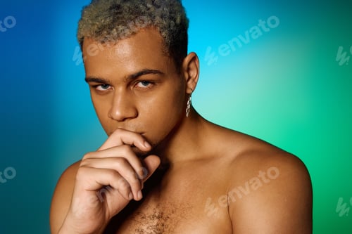 Preview: Striking beauty of a young man with dyed hair in a vibrant studio setting