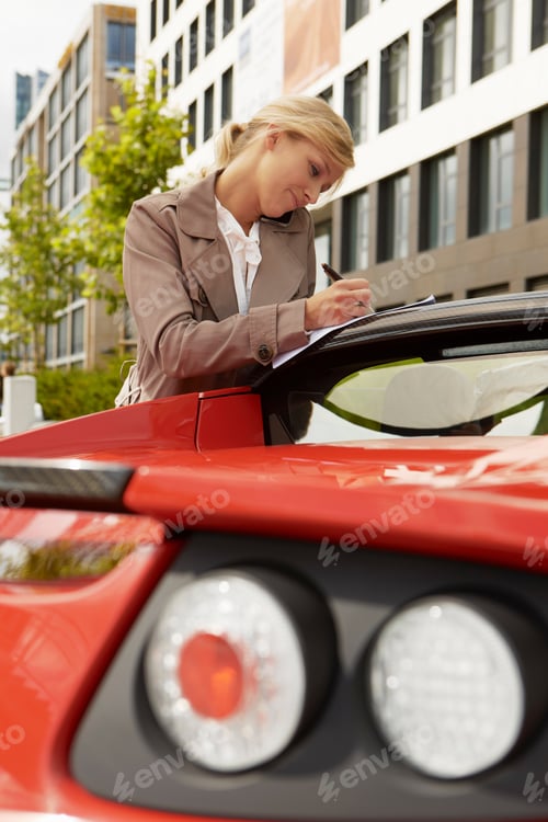Preview: Business woman on mobile phone with car