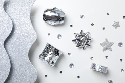 Preview: Silver waves and items for gift decoron white background, top view