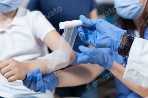 Preview: Closeup of african american pediatrician doctor bandage fractured injured arm