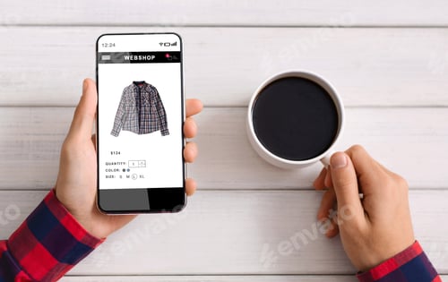 Preview: Male Hands Holding Smartphone Using Online Shopping App Sitting Indoor