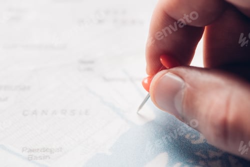 Preview: partial view of man putting pin on map, traveling concept