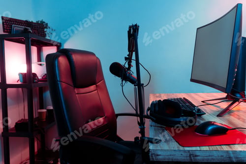 Preview: Black desk with a variety of gaming equipment such as keyboards, controllers, and headsets