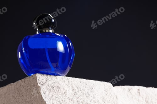 Preview: Bottle of perfume on cinder block close up
