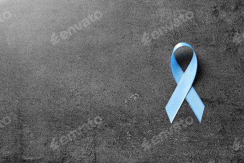 Preview: Blue ribbon on grey background, top view. Cancer awareness