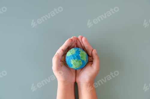Preview: Hands holding earth paper and water paint. Concept of sustainability environment protection