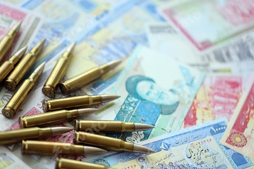 Preview: Many bullets and iranian rials money bills close up. Concept of terrorism funding
