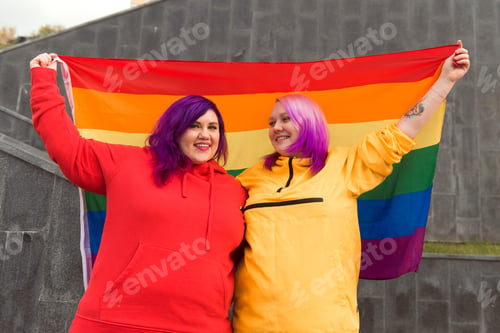 Preview: happy young women lesbian holding lgbtq pride flag