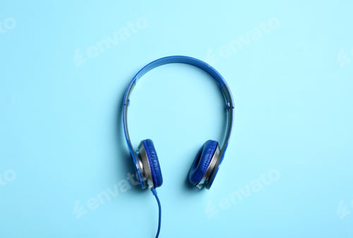 Preview: Stylish headphones on color background, top view