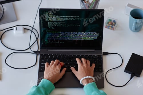 Preview: Woman writing computer codes on laptop