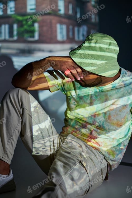 Preview: good looking african american male model posing with hand closing his face, fashion concept