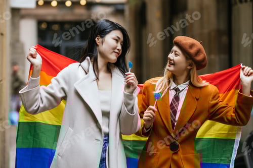 Preview: Two Women Holding a Rainbow Flag in the City