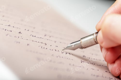 Preview: Hand holding a fountain pen while writing on a sheet of paper