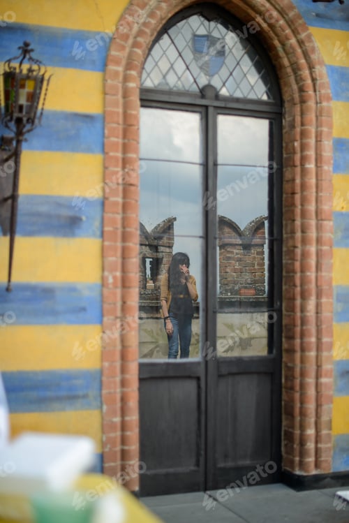Preview: Reflective contemplation at a striped artistic building entrance