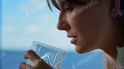 Preview: Depressed woman holding alcohol glass closeup. Upset businesswoman in office