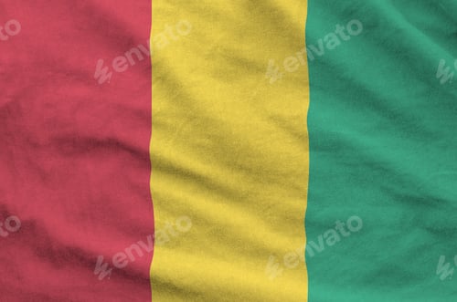 Preview: Guinea flag depicted on folded wavy fabric of old cloth