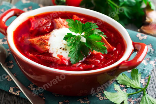 Preview: Beetroot soup with meat, sour cream and parsley in a brown ceramic bowl on the old wooden background