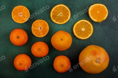 Preview: top view oranges with grapefruit and tangerines on green background