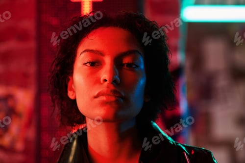 Preview: Face of young African American woman with short hair looking at camera