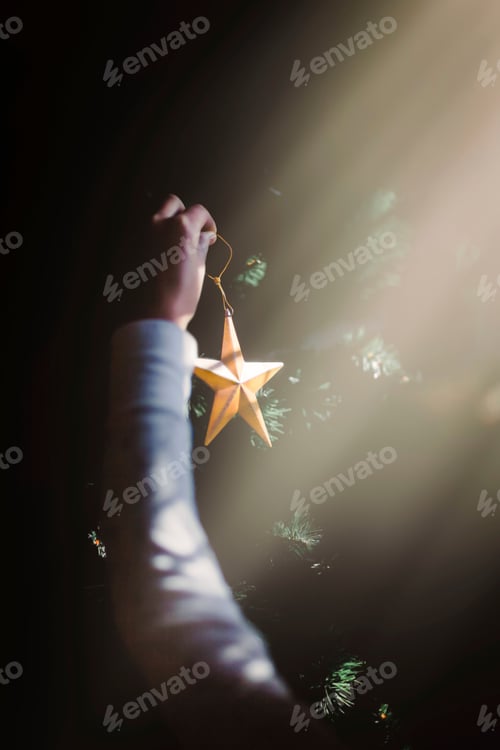 Preview: Child putting up Christmas decorations