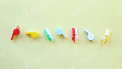 Preview: Vintage toy whistles on yellow background