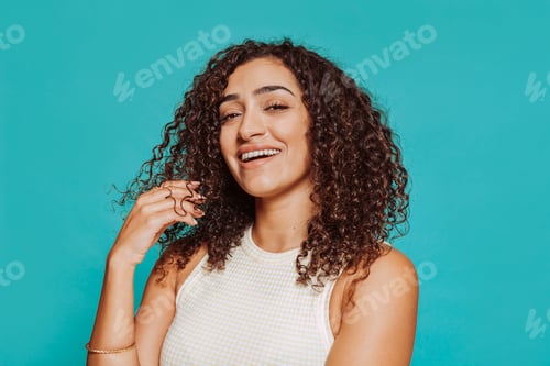 Preview: Young happy smiling african girl touches her hair