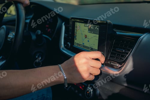 Preview: Close-up of a man touching the buttons on the screen of a car