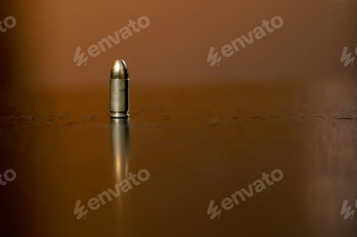 Preview: in a professional shooting range there is a ninth-caliber bullet on a black table introductory