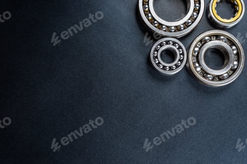 Preview: Ball bearing lying on a black background, flat view from above.